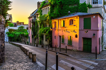 Sunset view of cozy strert in quarter Montmartre in Paris, France