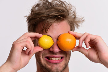 Man with orange and lemon instead of eyes in hands