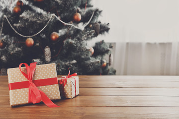 Christmas presents on decorated tree background, holiday concept