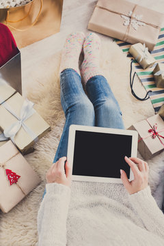 Woman christmas shopping online with tablet, top view