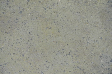 Pale yellow flat grey concrete slab from above