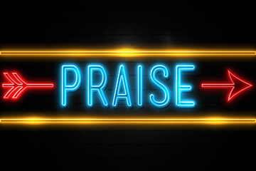 Praise  - fluorescent Neon Sign on brickwall Front view