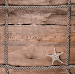 Fototapeta na wymiar Rope frame on a wooden background