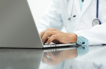 Close up ,Portrait of a professional male doctor using his laptop computer in office ,health care and Technology concept.