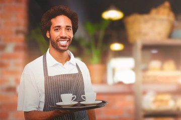 Composite image of waiter holding cup of coffee on a tray