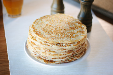 Pile of russian pancakes over the plate at restaurant