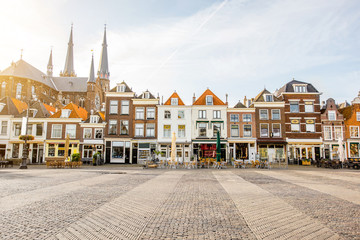 View on the beautiful buildings facades and church on the central square during the sunny morning...