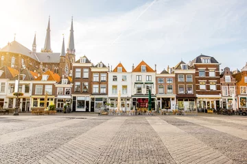  View on the beautiful buildings facades and church on the central square during the sunny morning in Delft city, Netherland © rh2010