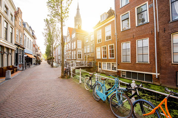 View on the beautiful old buildings and water channel in Delft town during the morning light, Netherlands