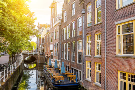 View on the beautiful old buildings and water channel in Delft town during the morning light, Netherlands