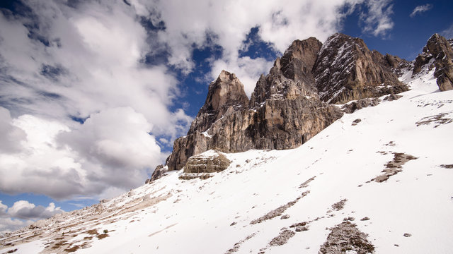 South Tyrol Dolomites covered with snow with cloudy and blue background
