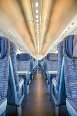 Fototapeta premium Empty rail passenger carriage seat rows with dimishing perspective