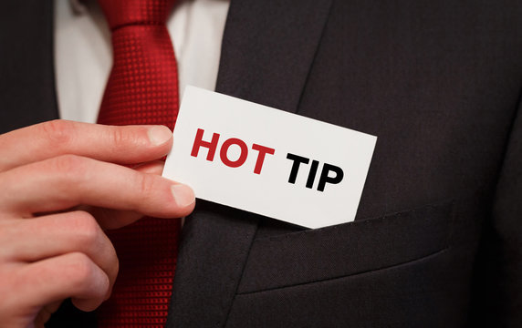 Businessman Putting A Card With Text Hot Tip In The Pocket