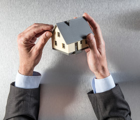 businessman hands looking at roof for house valuation or insulation