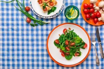 Eating healthy food on checkered tablecloth background, top view.