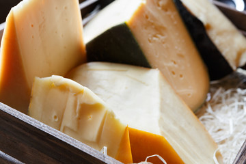 Hard cheese assortment. Edammer, gruyere, pecorino at grocery shop background