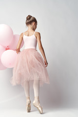 ballerina holding balloons