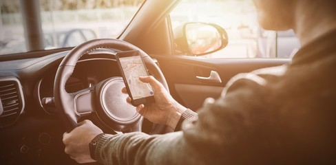 man looking at GPS on his phone