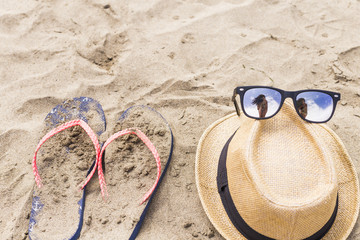 Beach accessories, summer outfit. flip flop, hat and sunglasses with a selfie reflection....