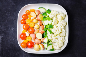 Raw vegetables in a baking dish.  Top view, copy space.