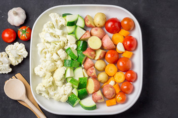 Raw vegetables in a baking dish.  Top view.