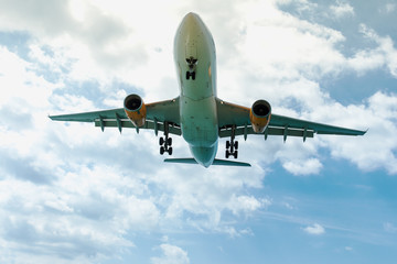Fototapeta na wymiar Low angle view of flying airplane at blue sky. 