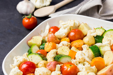 Various vegetables - tomatoes, cauliflower, zucchini, potato. Ready for roasting. Selective focus.