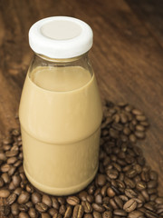 Coffee milk with coffee bean on wood table