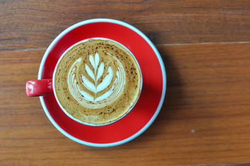 red  cup of hot coffee on wooden table in coffee shop,red cup