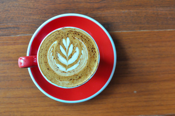 red  cup of hot coffee on wooden table in coffee shop,red cup