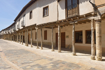 Obraz premium Street with arcades in Ampudia, Tierra de Campos, Palenciia province, Castilla y Leon, Spain