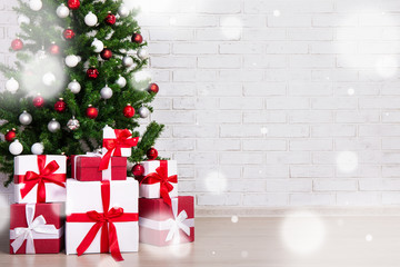 winter concept - decorated christmas tree with colorful balls and gift boxes