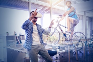 Composite image of fit man cycling on rocky terrain