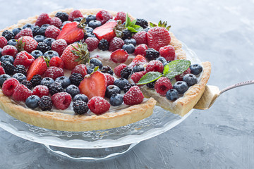 Tart on the plate close up. Homemade dessert with delicious l cream and fresh berries