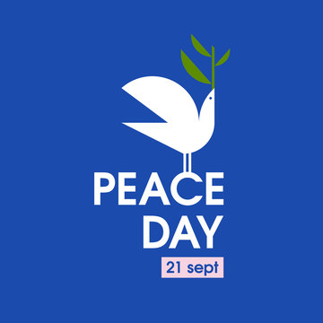 Peace day card with white pigeon with olive branch on a blue