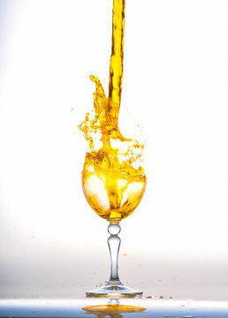 orange wine splash in the glass on white background,orange  water drop splash on white background