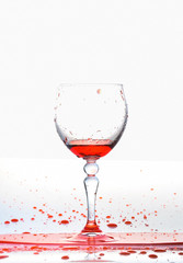 red wine splash in the glass on white background,red water drop splash on white background
