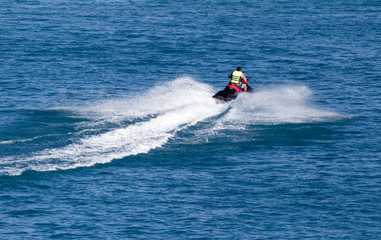 Obraz premium jet ski on the surface of the water at a speed of