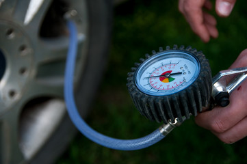 Fototapeta premium Checking the Flat tyre with the air compressor.