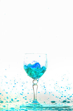 blue wine splash in the glass on white background,blue water drop splash on white background