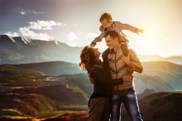 Happy family fun concept at sunset