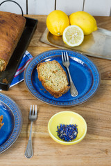 Cake. Lemon zucchini bread. Wooden table, blue plate, white background.