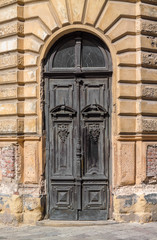 Fototapeta na wymiar The door of the old European building. Exterior design element of ancient Lvov. Example of world architectural heritage.