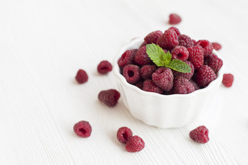 Plate with raspberries on a wooden table