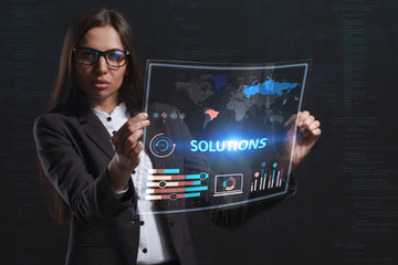 The concept of business, technology, the Internet and the network. A young entrepreneur working on a virtual screen of the future and sees the inscription: Solutions
