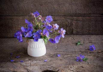 blue flowers on old wooden background