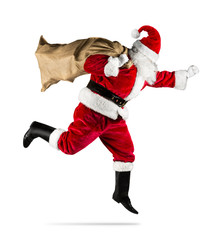 red traditional santa claus with bag of christmas gifts presents running jumping isolated on white...