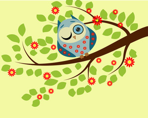 Peeping. a blue owl in red flowers with one closed and one open eye sitting on a branch of a flowering tree