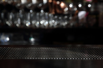 Counter bar with glass background in dark tone - obrazy, fototapety, plakaty