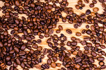 Pile of the roasted coffee beans on wooden table. Top view